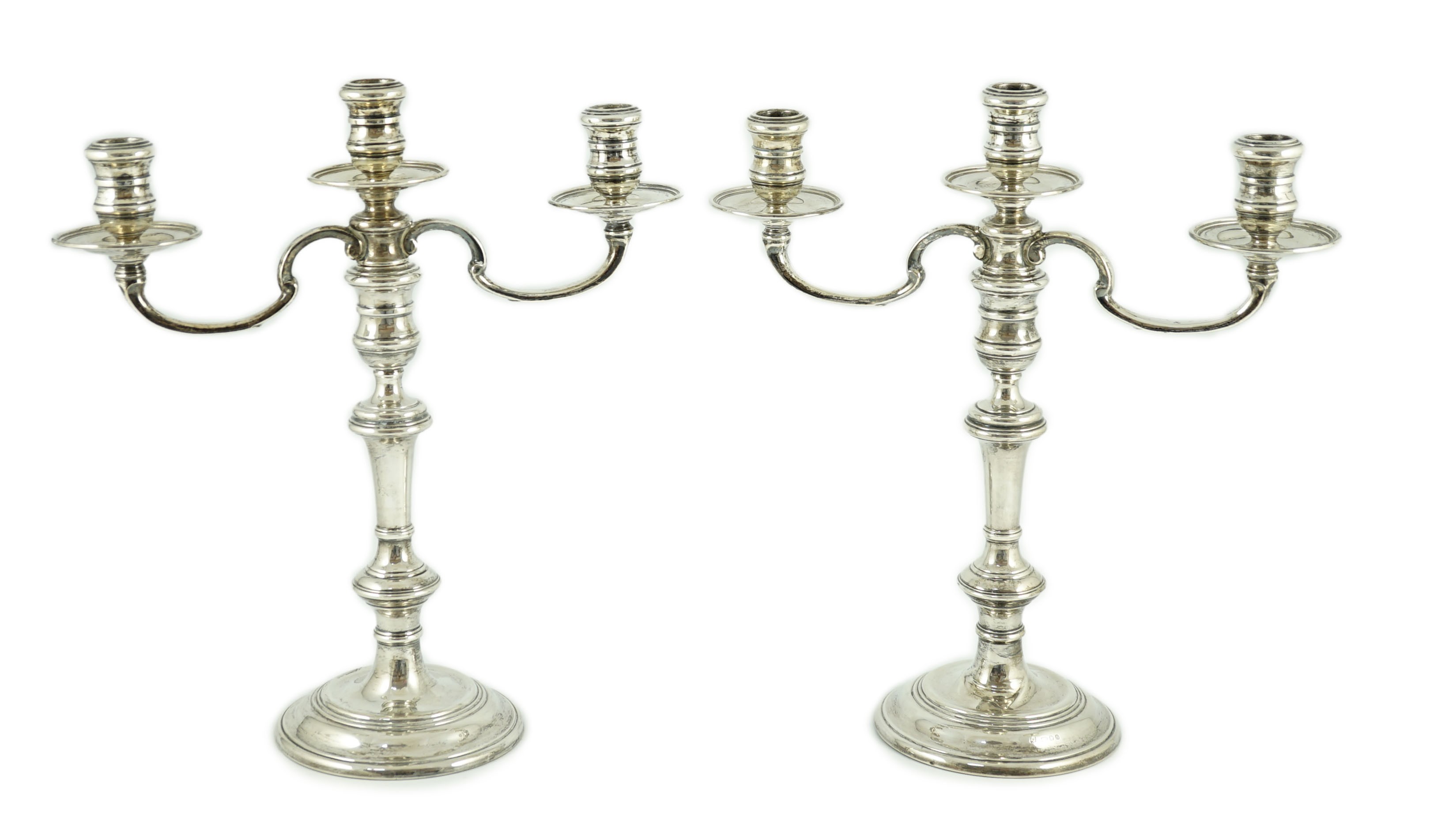A modern pair of silver two branch, three light candelabra by William Comyns & Sons Ltd